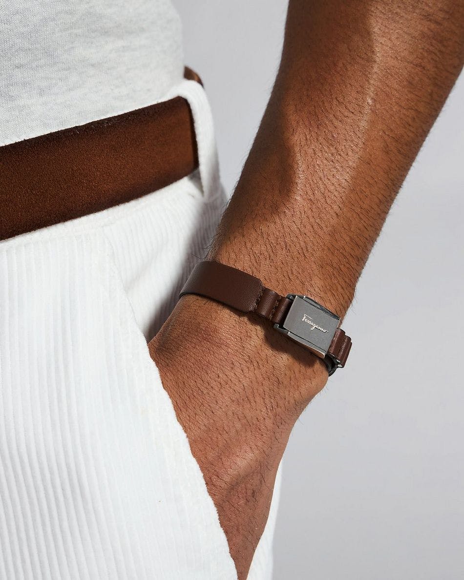 man wearing brown Ferragamo bracelet