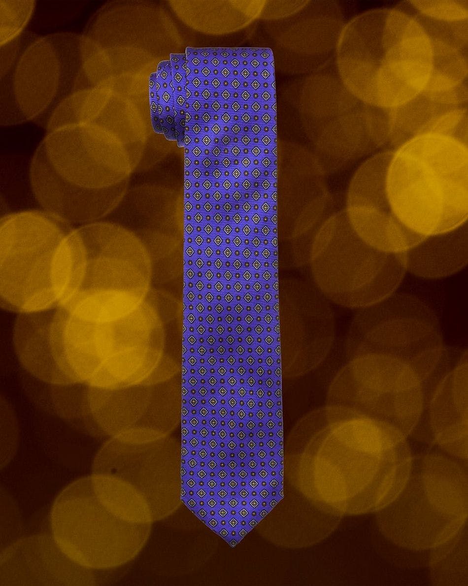 Purple patterned tie on yellow blurry bubbles background